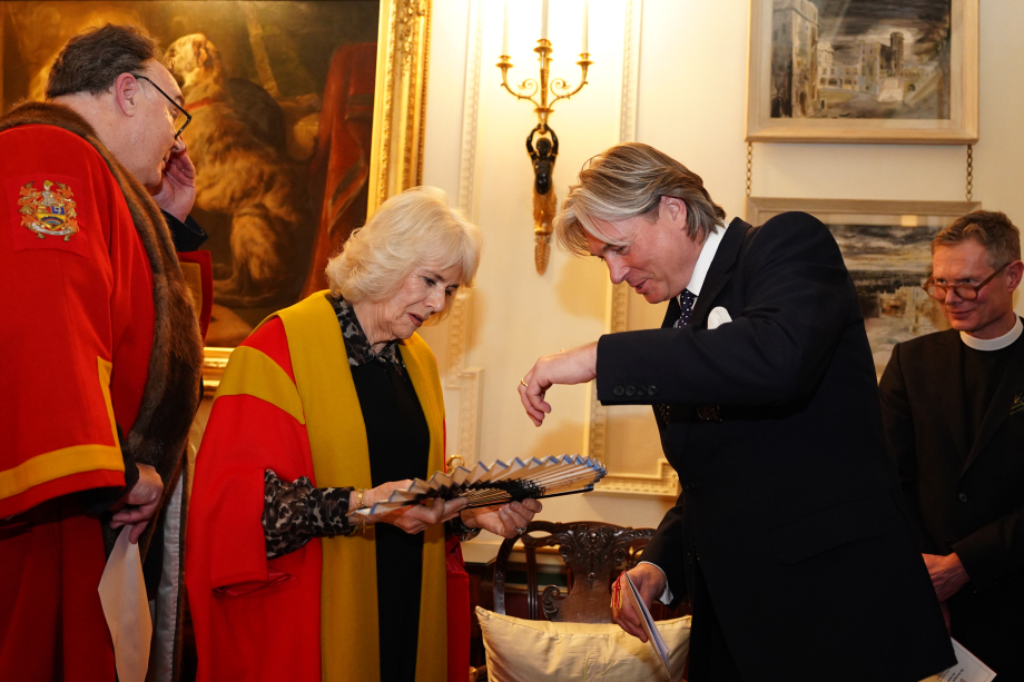 The Queen is presented with a fan at Clarence House