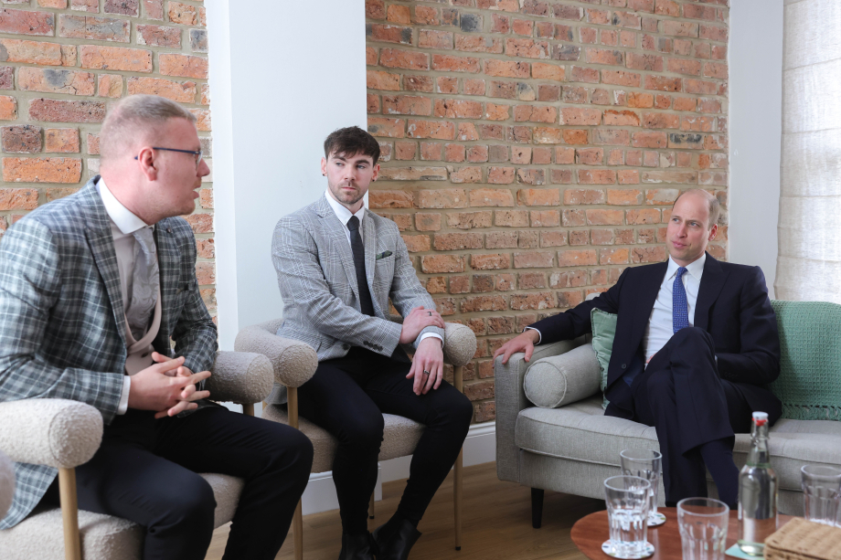 The Prince of Wales sits with two men at the opening of James' Place