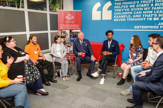 The Prince of Wales chats with young people in a group discussion who have been helped by The Prince's Trust