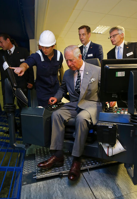 The Prince of Wales takes the controls of a gantry crane as he visits MVV Energy