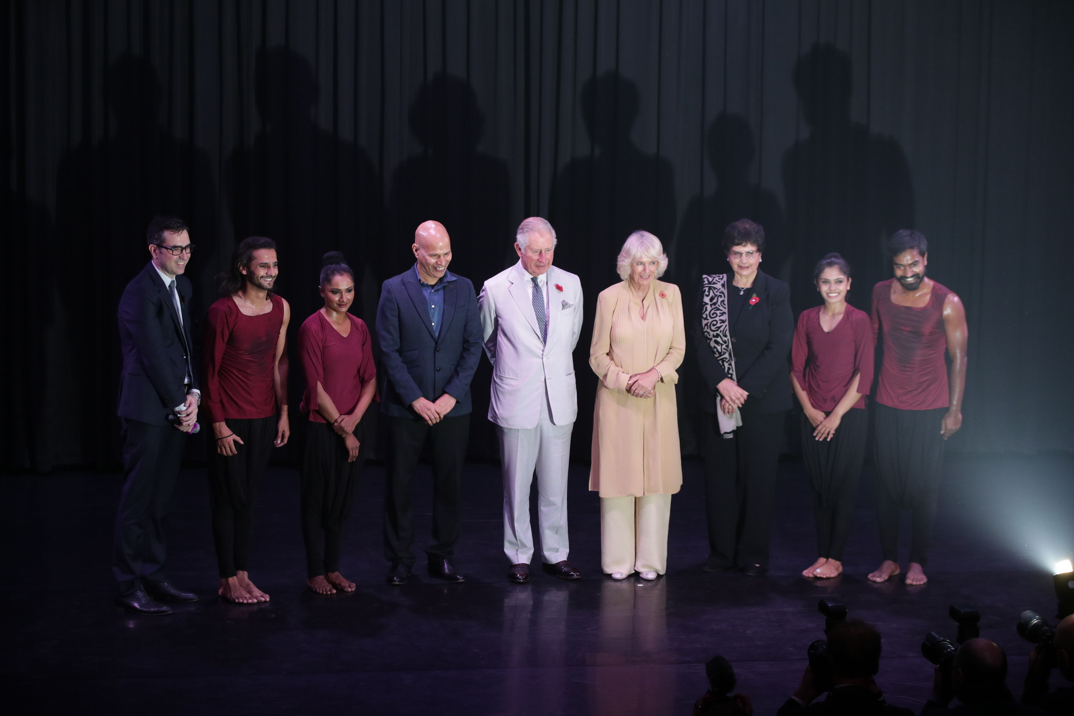The Prince of Wales and the Duchess of Cornwall join members of the Attakkalri Dance Company on stage at the British Council in New Delhi, India