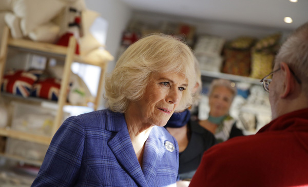 The Duchess of Cornwall talks to former prisoners during a visit to the Fine Cell Works Hub in London