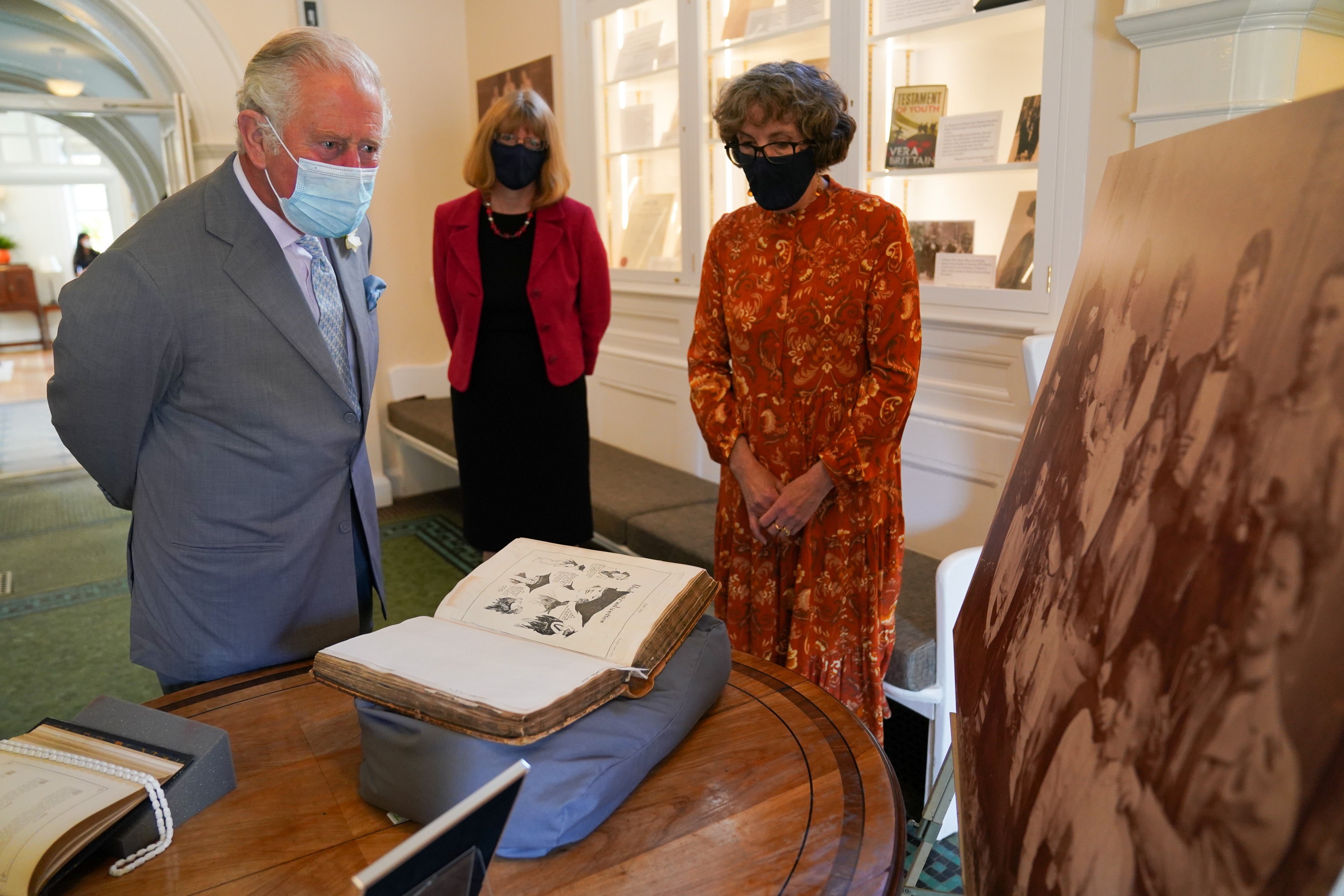 The Prince of Wales viewing an exhibition on the centenary of women receiving degrees during his visit to Somerville College in Oxford