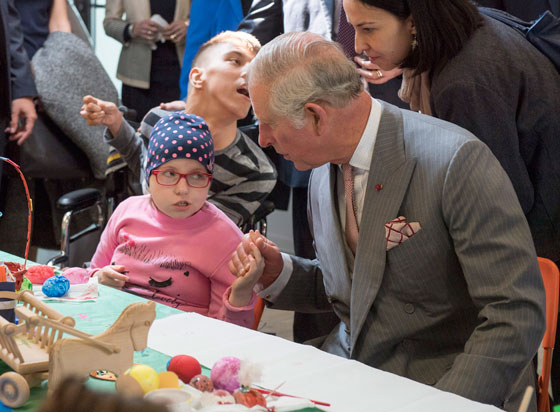 The Prince of Wales meets Maria Mihai during a visit to the Hospices of Hope in Bucharest