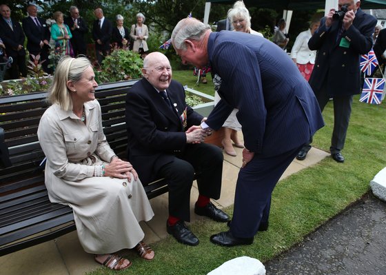 The Duke of Rothesay talks with 96 year old John Moffat and his daughter Jan Moffat Osband during a visit to Abbeyfield, Viewlands House in Perth.