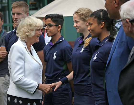 The Duchess of Cornwall chats with ball boys and girls during a visit to the Lawn Tennis Championships at the All England Lawn Tennis Club.