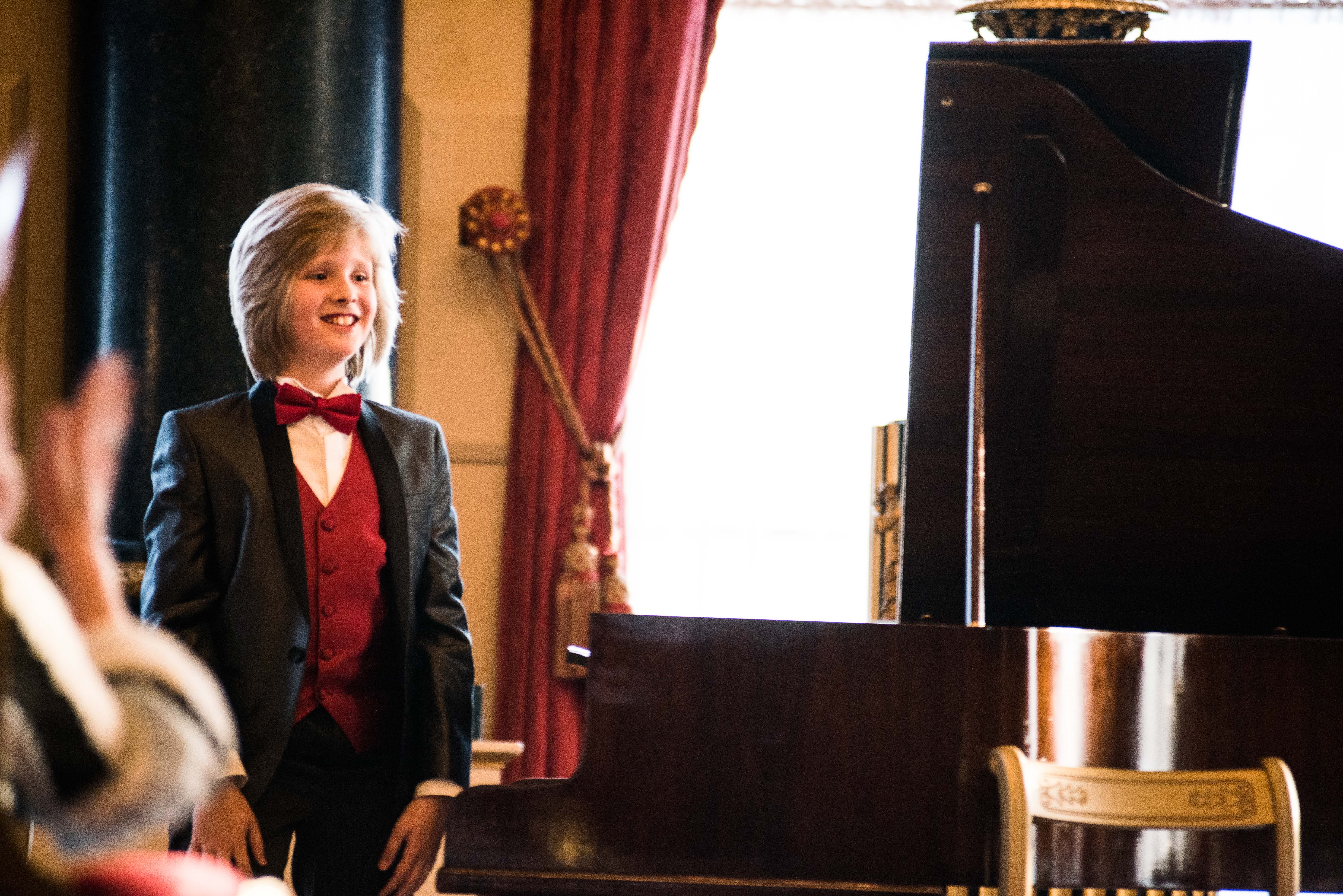 Sebastian beside the piano
