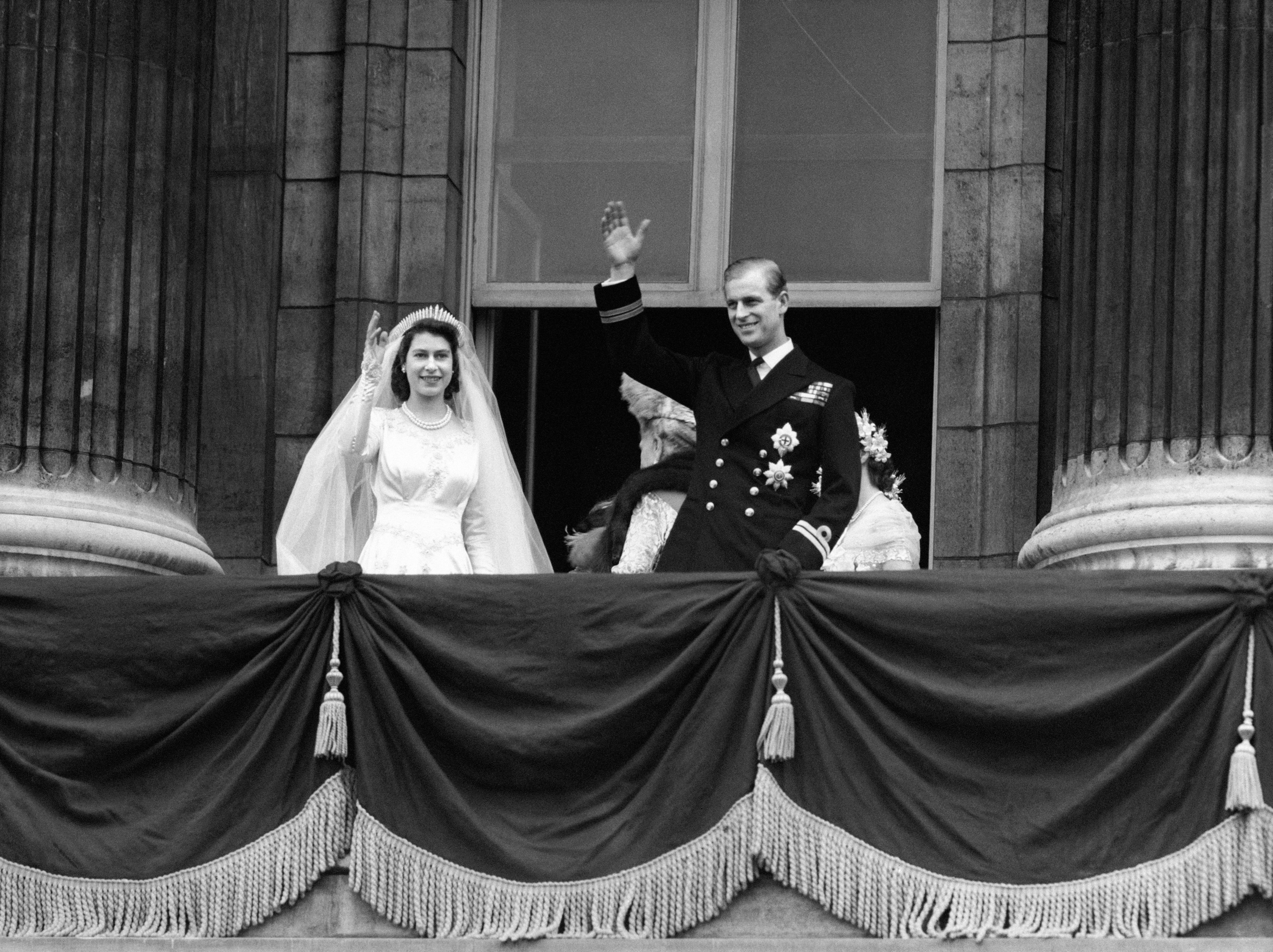 The Royal couple wave to crowds from balcony of Buckingham Palace