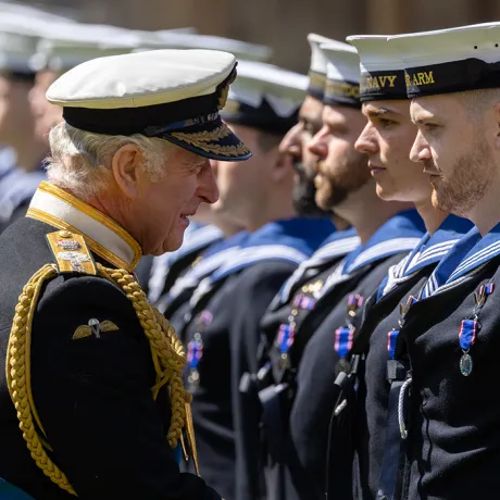 The King presents Royal Navy personnel with RVO medals