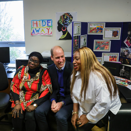 The Prince of Wales has a photo with two members of the Moss Side community at The Hideaway Youth Project