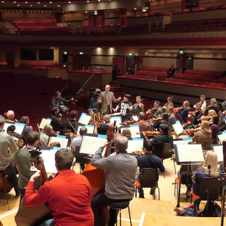 The Duke of Edinburgh conducting on stage