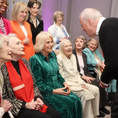 Gyles Brandreth speak to Queen Camilla as whilst posing for a photo with Floella Benjamin, Twiggy Lawson, Harriet Walter, Maureen Lipman (left to right front row) Virginia McKenna, Sian Phillips, Vanessa Redgrave, Penelope Keith and Patricia Routledge at a Celebration of Shakespeare event at Grosvenor House, central London, marking 400 years since the first…