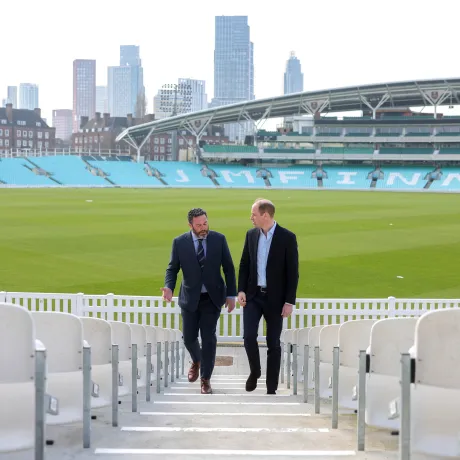 The Prince of Wales walks up the steps at The Kia Oval cricket ground in London