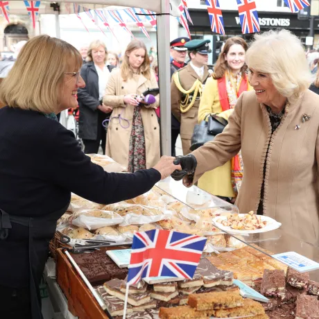 Queen Camilla meets a trader during a visit to the Farmers' Market in The Square, Shrewsbury, in Shropshire.