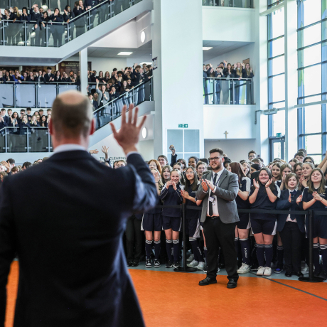 The Prince of Wales waves to students at St Michael's CE High School
