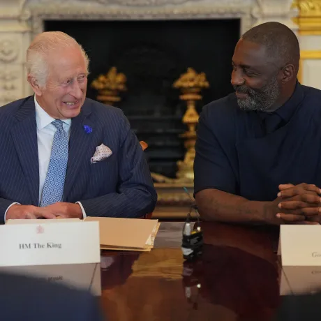 (L-R): His Majesty The King sat next to Idris Elba. Both men are chuckling