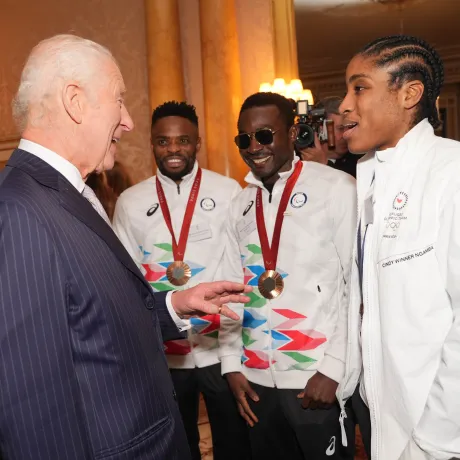 The King speaks to Cindy Ngamba at Buckingham Palace