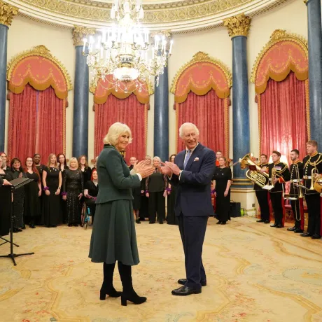 The Queen and King (L-R) applauding a performance by the MWC at Buckingham Palace