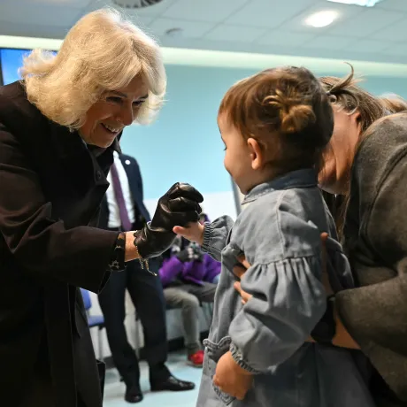 The Queen holding the hand of a young child at Great Western Hospital