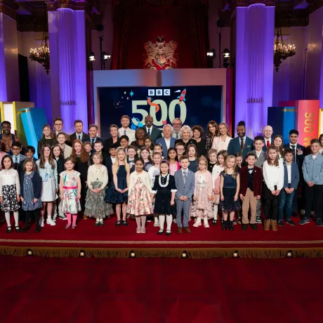Group photo of The Queen with guests at the 500 Words Reception