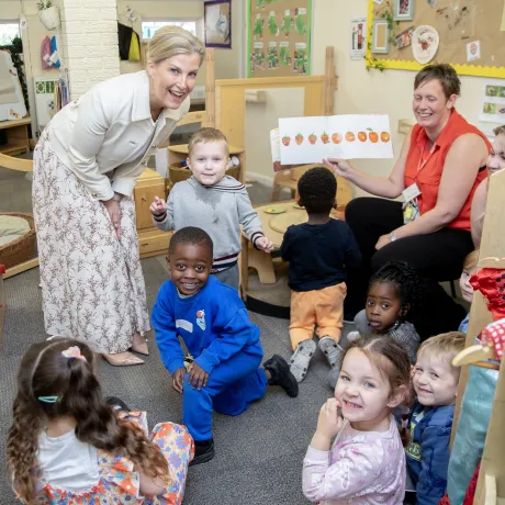 The Duchess of Edinburgh smiles with a group of nursery children