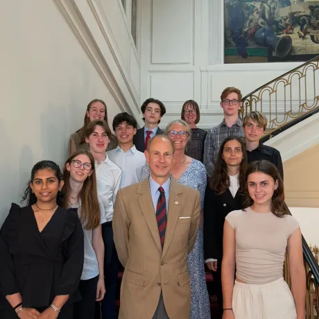 The Duke of Edinburgh smiles alongside IAF Gold Award students 