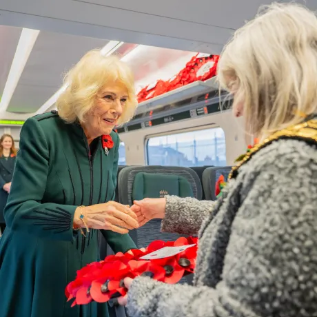 The Queen meets a member of the local community on the train at Chippenham