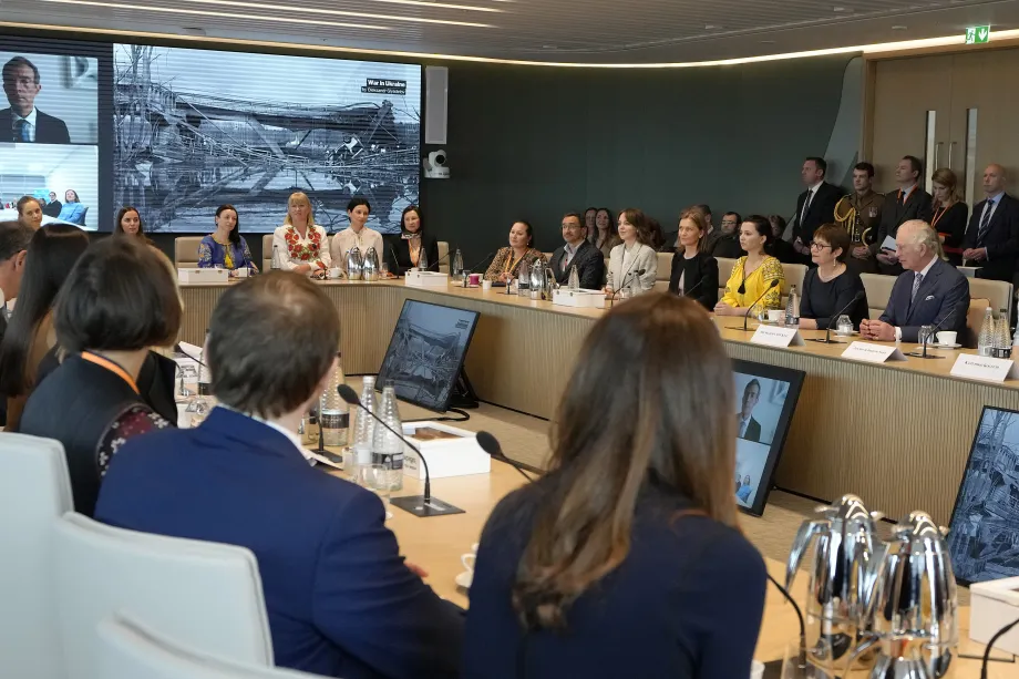 The King sits at a large conference table
