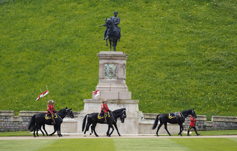 Members of the Royal Canadian Mounted Police ride through the Quadrangle of Windsor Castle