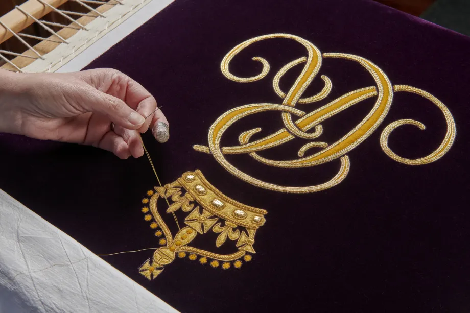 The Royal School of Needlework work on The Queen Consort's Robe of Estate