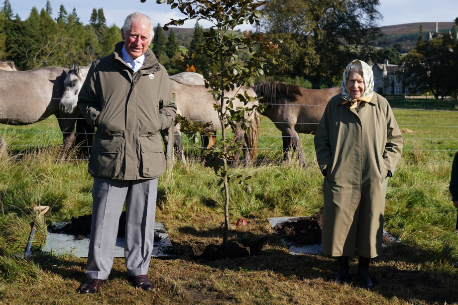 Queen Elizabeth and the then Prince of Wales plant a tree in the grounds of Balmoral Castle 