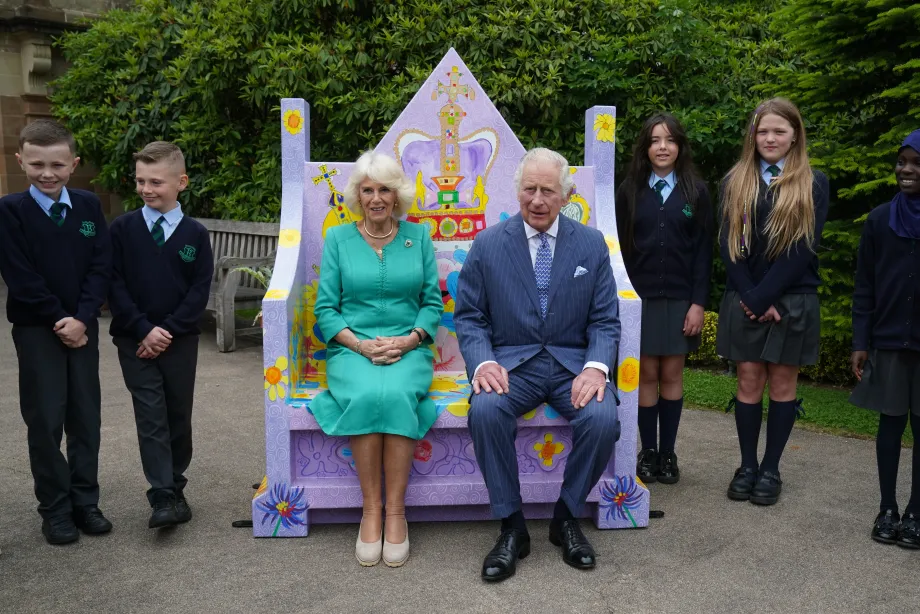 Their Majesties sit on the Coronation Bench