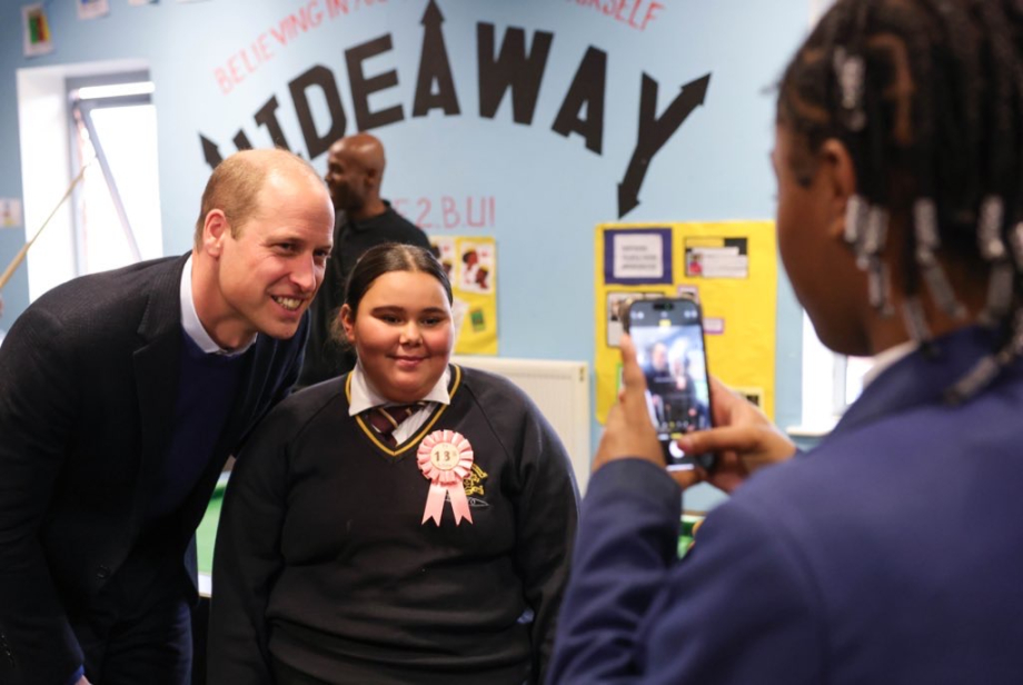 The Prince of Wales has a photo taken at The Hideaway Youth Project
