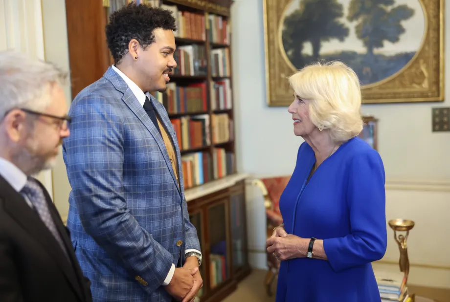 Queen Camilla speaks to author Jonathan Escoffery, who is nominated for 'If I Survive You', during a reception at Clarence House, London, for the Booker Prize Foundation.