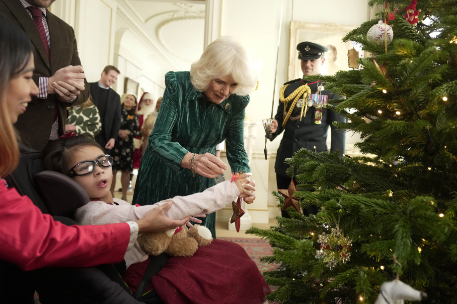 The Queen is joined by children to decorate the Clarence House Christmas Tree