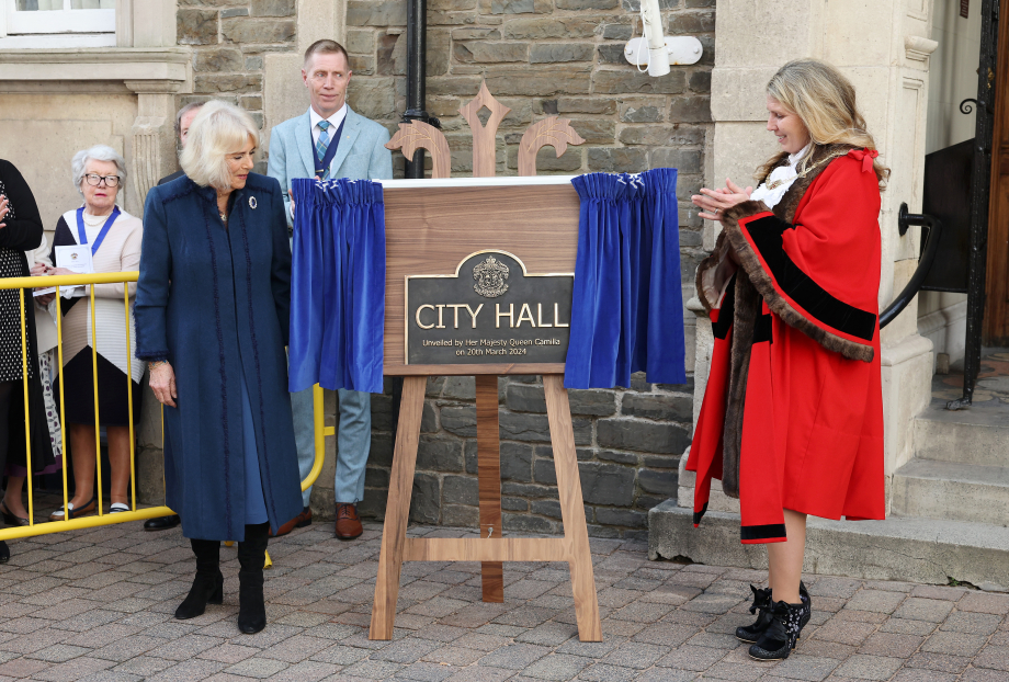 Queen Camilla prepares to unveil a commemorative plaque to mark the conferring City status on the Borough of Douglas during a visit to the Isle of Man.