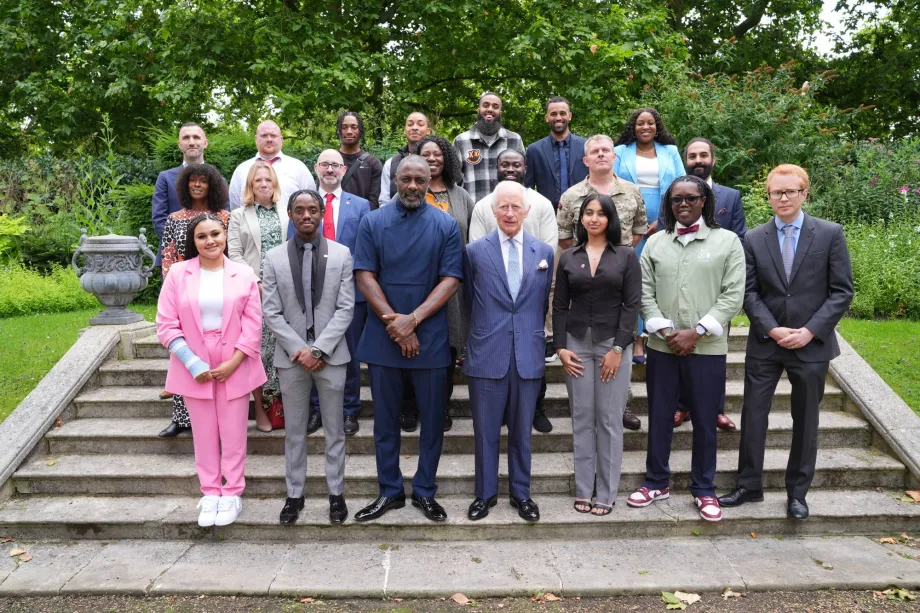 A group photo including His Majesty The King, Idris Elba and young people