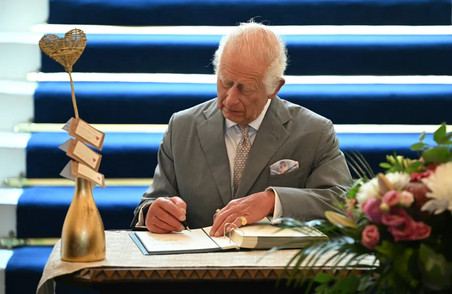 The King signs a book of condolence 