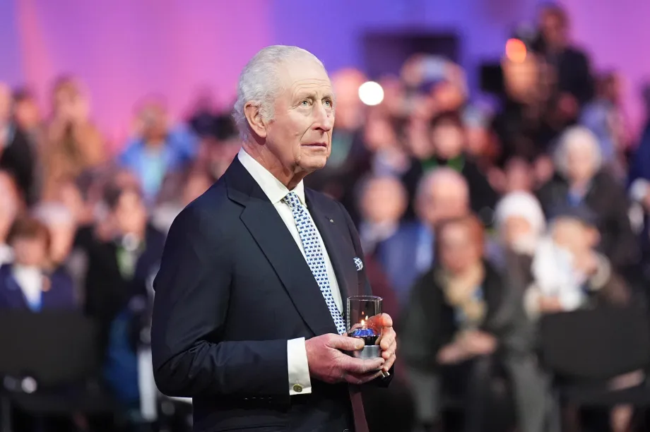 The King lights a candle at Auschwitz