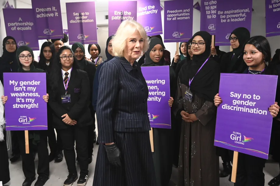 The Queen with pupils holding placards at Mulberry Academy