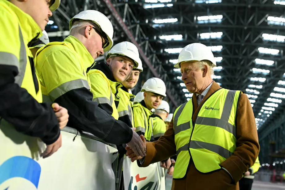 The King at an offshore turbine base factory