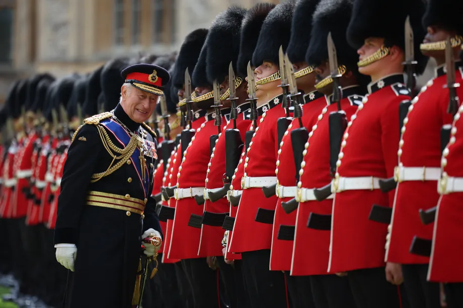The King speaks to a member of the Coldstream Guards on parade