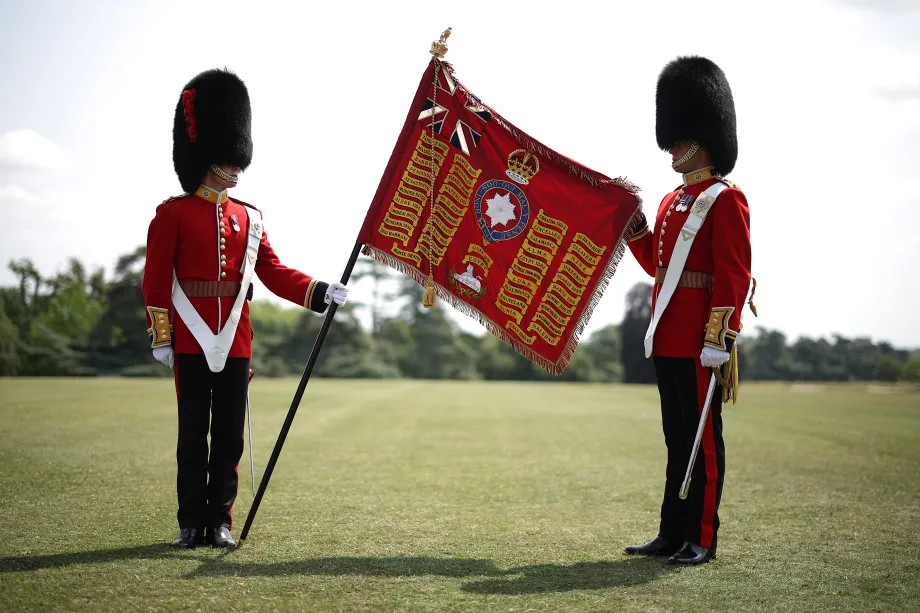 Soldiers of the 1st and 2nd Battalion (Number 7 Company) of the Coldstream Guards display the King's Colour at Windsor Castle
