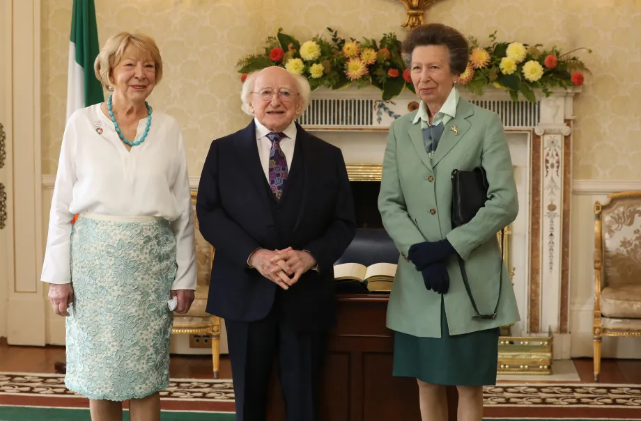 The Princess Royal smiles alongside President Higgins and his wife Sabina Higgins