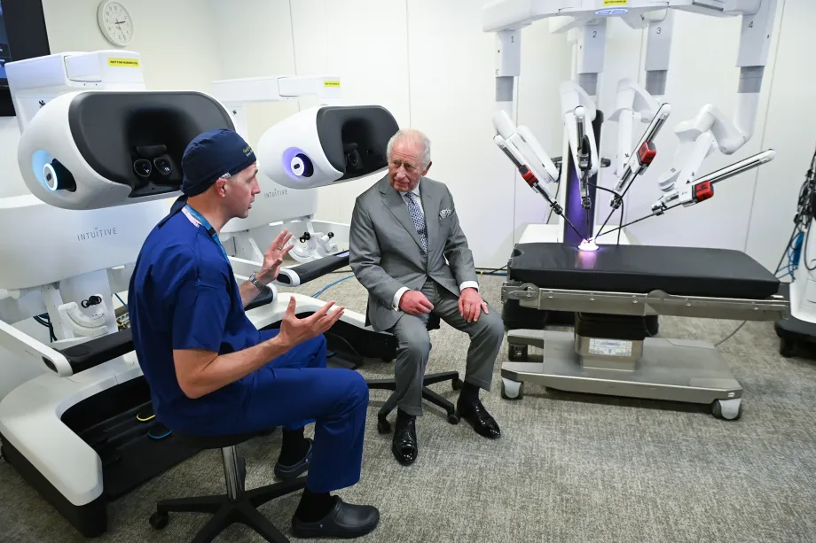 The King speaks to a doctor about the research the hospital is conducting