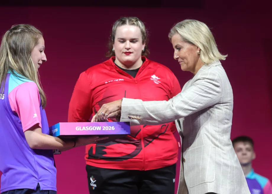 The Duchess of Edinburgh presents a bronze medal o Etta Mae Love of Canada following the Women's +86kg weightlifting final
