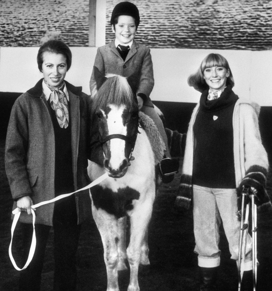The Princess Royal at the Riding for the Disabled Association centre in 1975 with eight year old Johnny, centre, who has spina bifida, and Blue Peter presenter Lesley Judd, right.