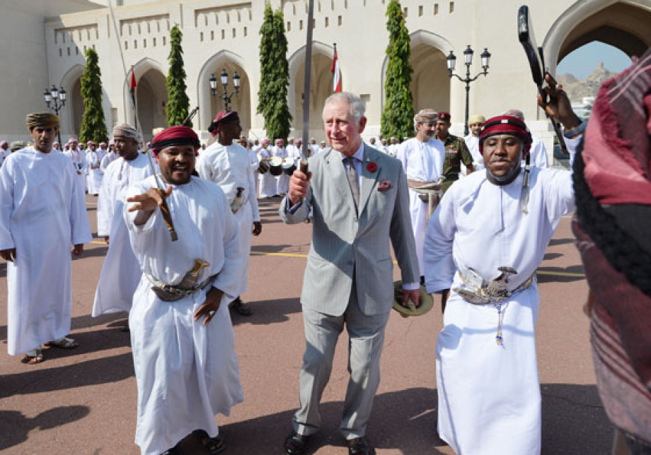 The Prince takes part in a ceremonial sword dance with local performers in Muscat, Oman