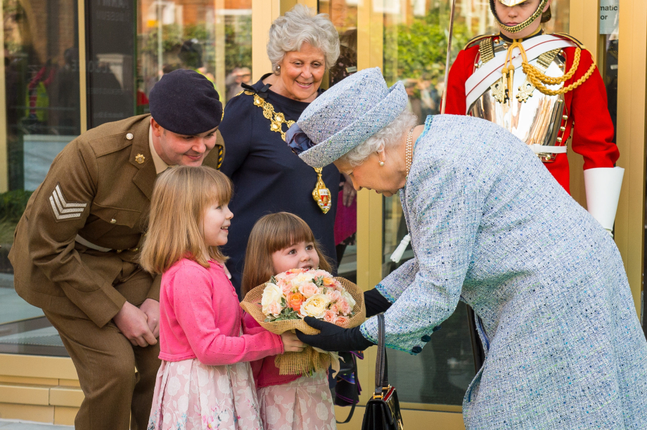 The Queen is presented with a posy after reopening the National Army Museum