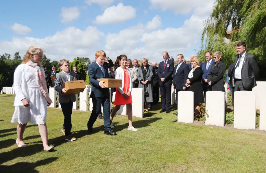 Children from Belgium, Northern Ireland and Ireland take part in a soil exchanging ceremony to promote peace